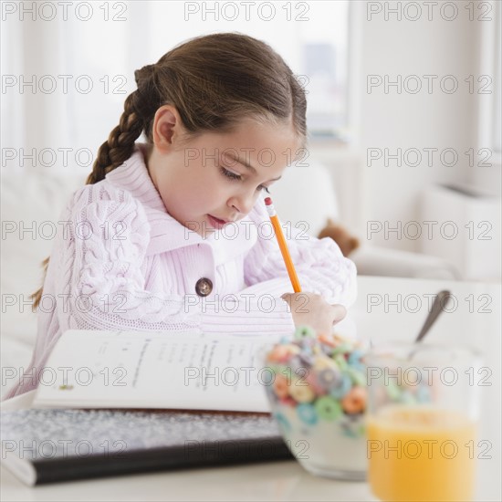 Young girl doing her homework. Photographer: Jamie Grill