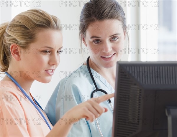 Nurses looking at computer. Photographer: Jamie Grill