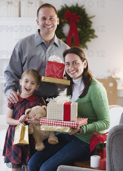 Family holding presents. Photographer: Jamie Grill