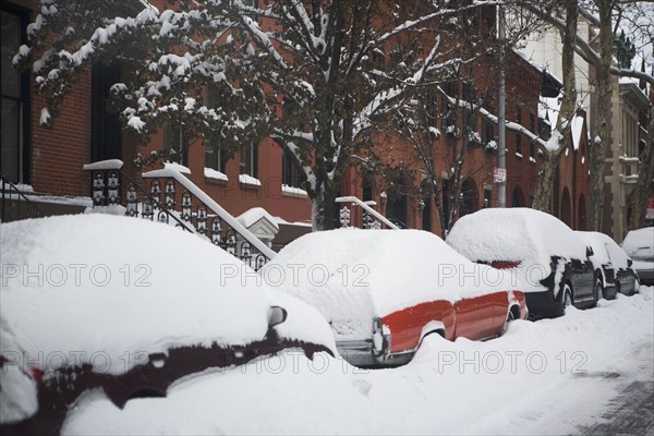 Cars covered in snow. Photographer: fotog