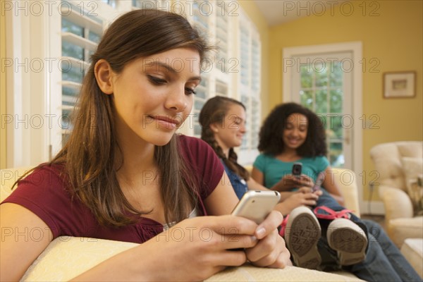 Friends texting. Photographer: mark edward atkinson