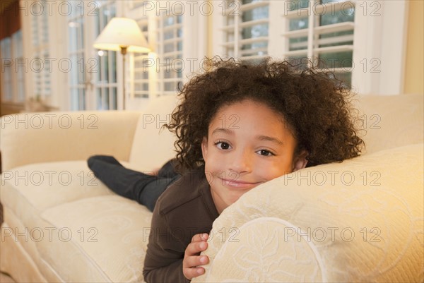 Young girl on couch. Photographer: mark edward atkinson