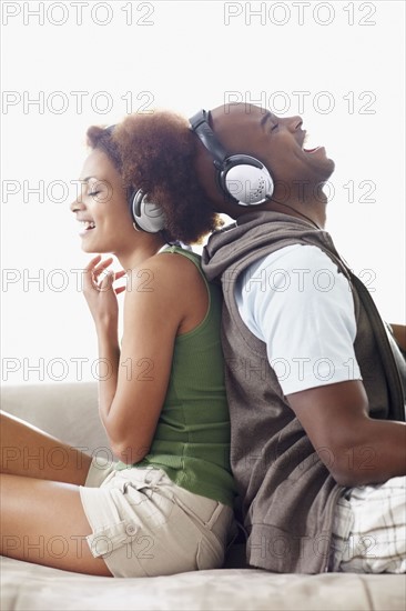 Couple wearing headphones. Photographer: momentimages