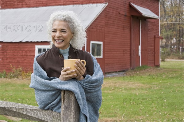 Woman holding mug outside. Photographer: Pauline St.Denis