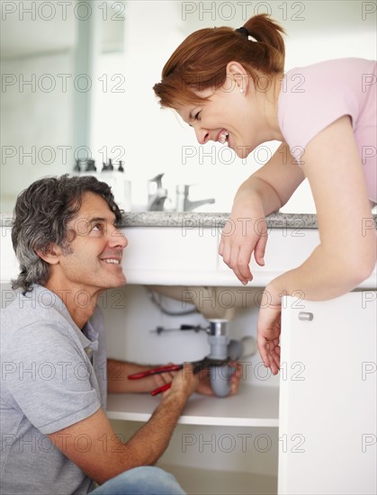 Fixing a leaky sink. Photographer: momentimages