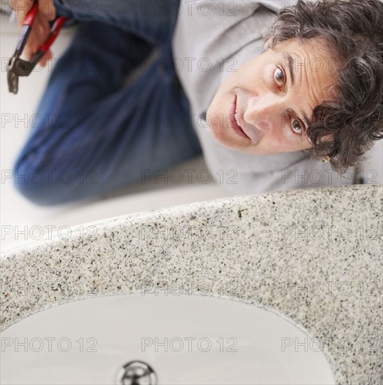 Fixing a leaky sink. Photographer: momentimages