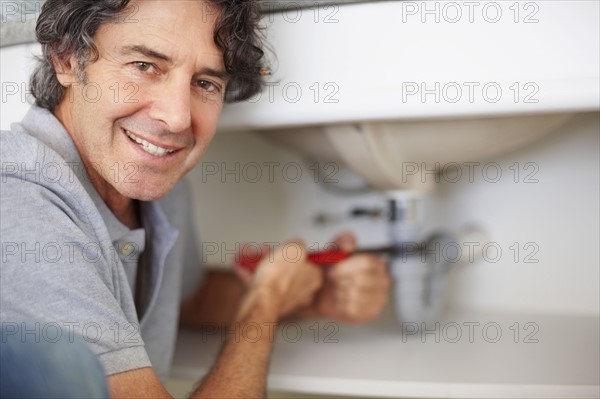 Fixing a leaky sink. Photographer: momentimages