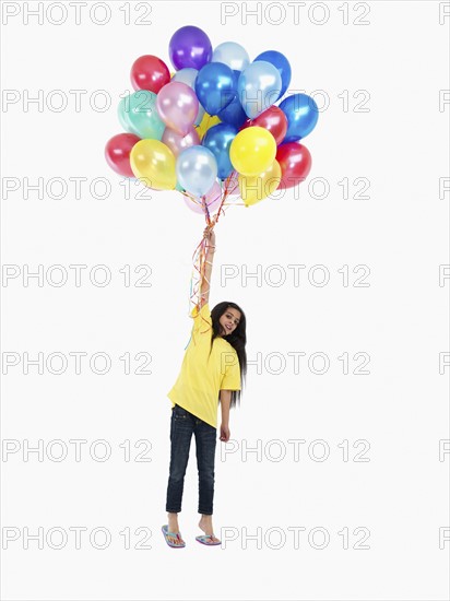 Girl holding balloons. Photographer: momentimages