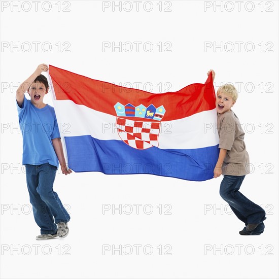 Two boys carrying flag. Photographer: momentimages