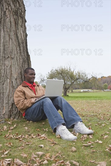 Man using laptop outside. Photographer: Pauline St.Denis