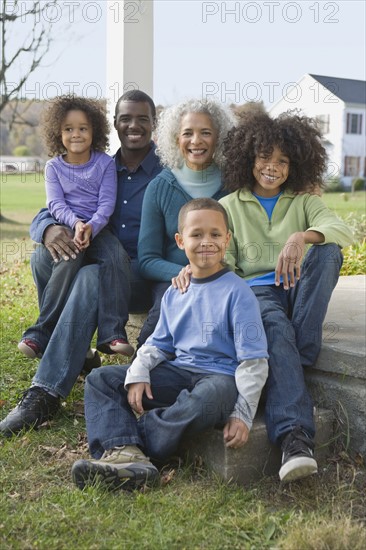 Family sitting on porch. Photographer: Pauline St.Denis