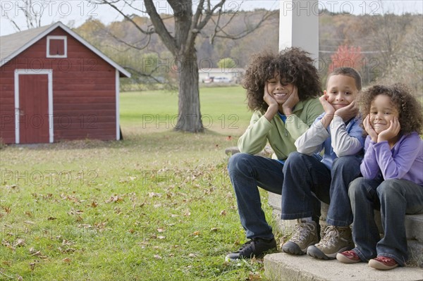 Family sitting on porch. Photographer: Pauline St.Denis