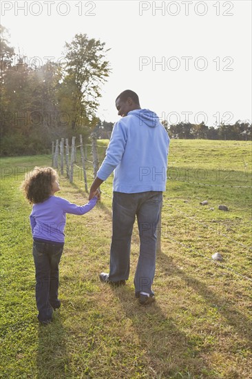 Father and daughter walking. Photographer: Pauline St.Denis