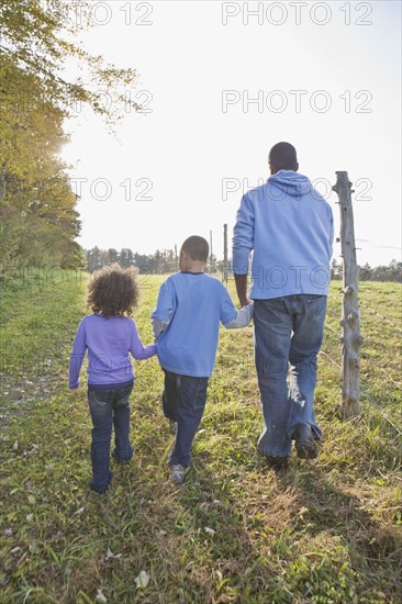 Father and children walking. Photographer: Pauline St.Denis