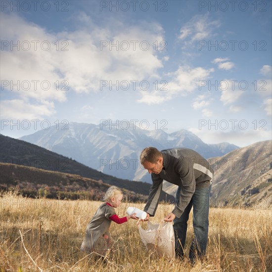 Father and child picking up litter. Photographer: Mike Kemp