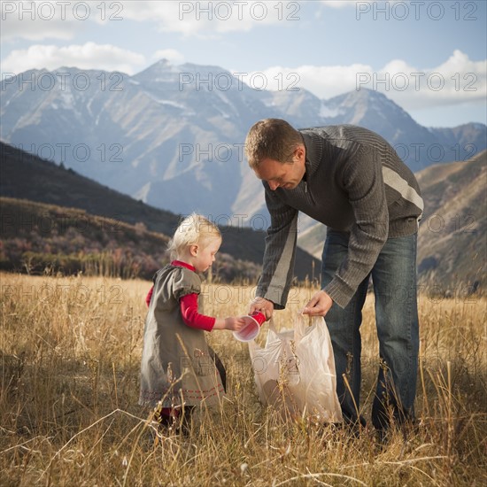 Father and child picking up litter. Photographer: Mike Kemp