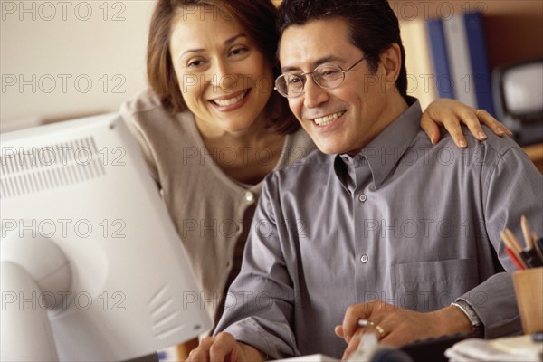 Couple working at computer in home office. Photographer: Rob Lewine