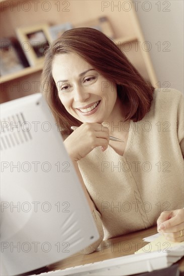 Woman working at computer. Photographer: Rob Lewine