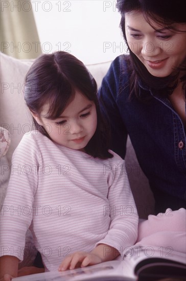 Mother and daughter reading together. Photographer: Rob Lewine