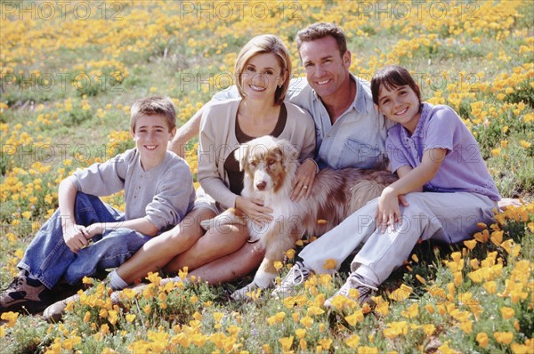 Portrait of a family in a meadow. Photographer: Rob Lewine