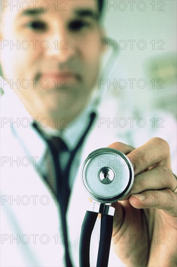 Doctor holding a stethoscope. Photographer: Rob Lewine