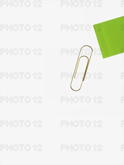 Paper clip and green paper. Photographer: David Arky