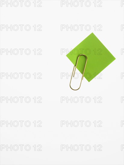 Paper clip and green paper. Photographer: David Arky