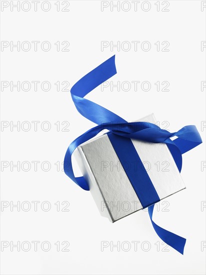 Gift and blue ribbon. Photographer: David Arky