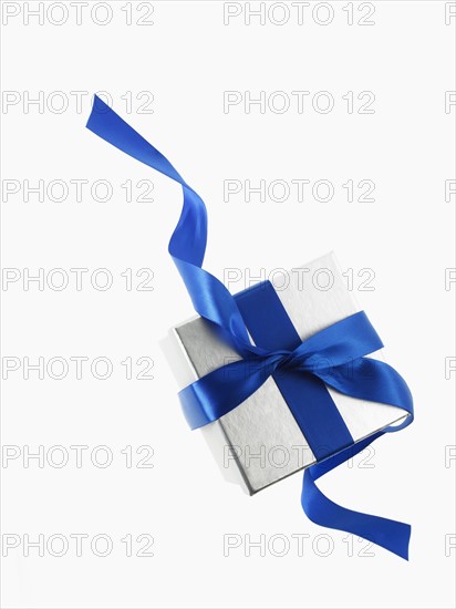 Gift and blue ribbon. Photographer: David Arky