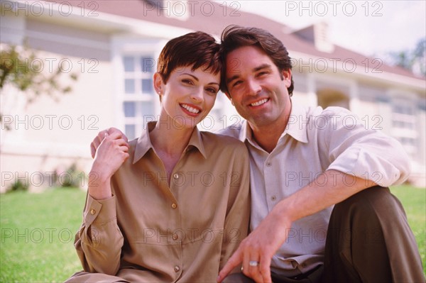 Couple sitting on lawn. Photographer: Rob Lewine