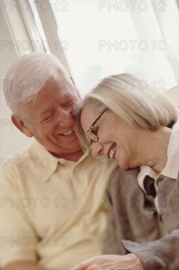 Elderly couple embracing. Photographer: Rob Lewine