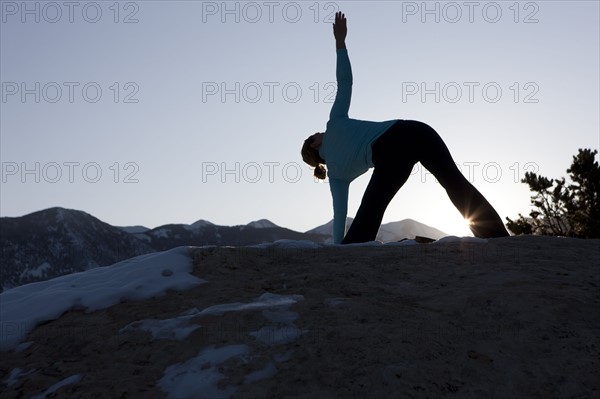 Woman doing yoga outdoors. Photographer: Dan Bannister