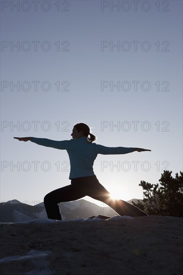 Woman doing yoga outdoors. Photographer: Dan Bannister