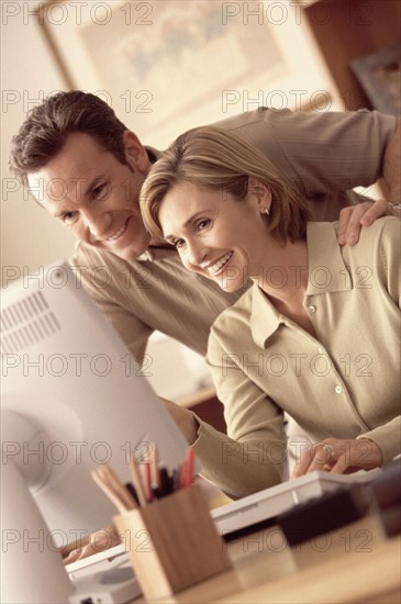 Couple looking at computer. Photographer: Rob Lewine