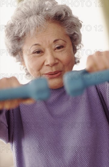 Senior woman exercising. Photographer: Rob Lewine