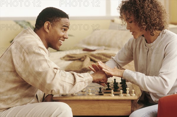 Couple playing chess. Photographer: Rob Lewine