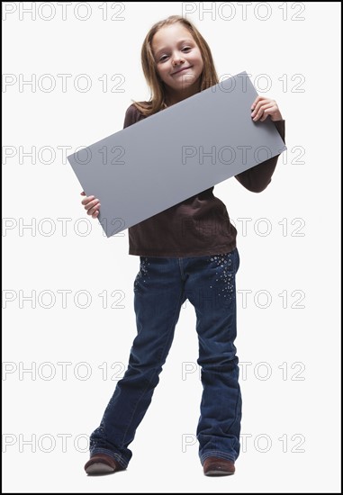 Young girl holding blank sign. Photographer: Mike Kemp