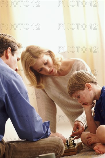 Family playing chess. Photographer: Rob Lewine