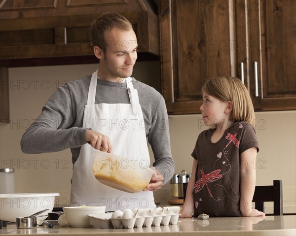 Father and daughter baking. Photographer: Mike Kemp