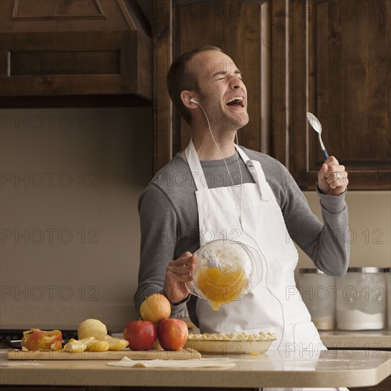 Man baking and listening to music. Photographer: Mike Kemp