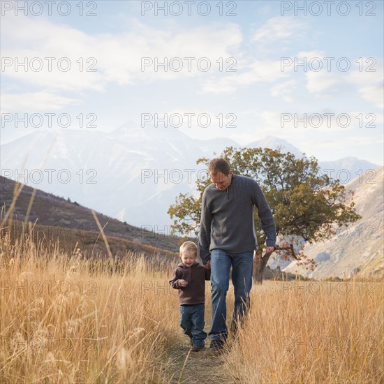 Father and son walking outdoors. Photographer: Mike Kemp