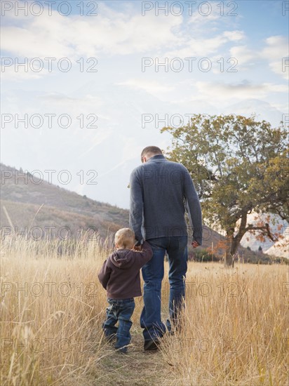 Father and son walking outdoors. Photographer: Mike Kemp