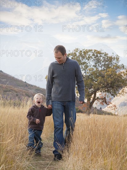 Father and son walking outdoors. Photographer: Mike Kemp