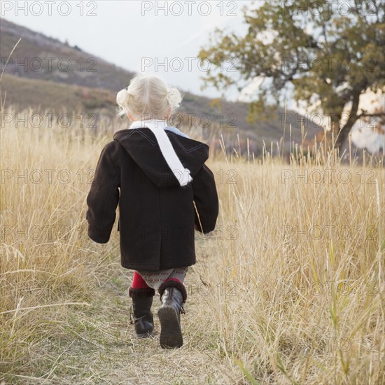 Girl walking in a meadow. Photographer: Mike Kemp