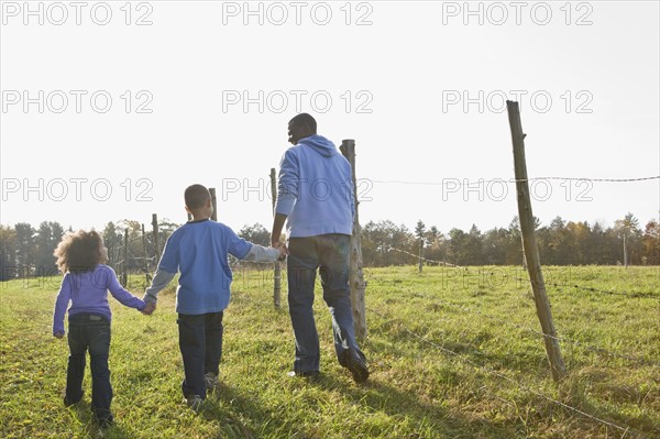 Father and children walking. Photographer: Pauline St.Denis