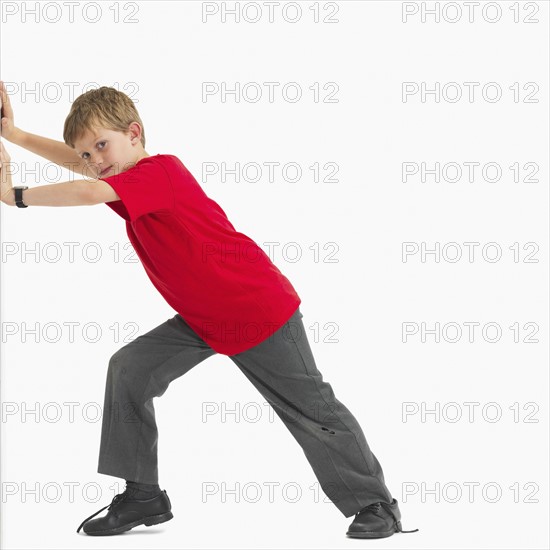 Boy pushing something. Photographer: momentimages