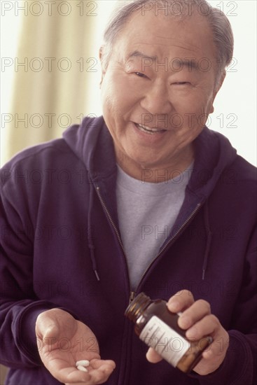 Man taking prescription medication. Photographer: Rob Lewine