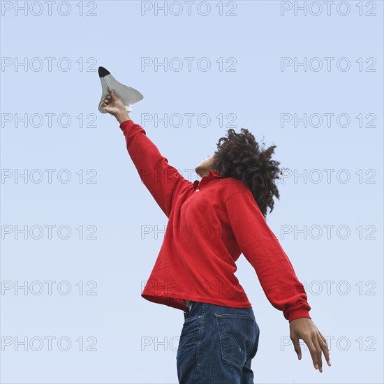 Woman flying toy plane. Photographer: Pauline St.Denis
