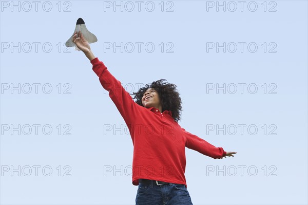 Woman flying toy plane. Photographer: Pauline St.Denis