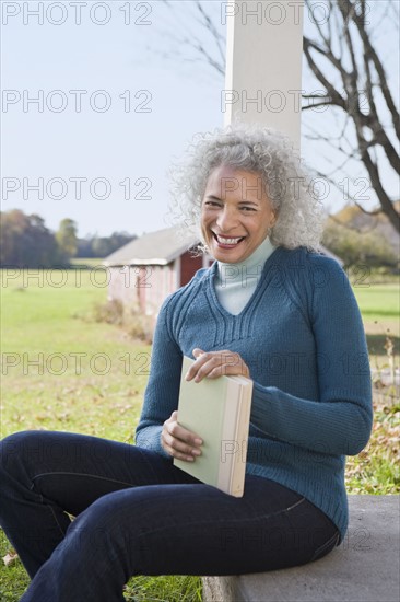 Woman holding a book. Photographer: Pauline St.Denis